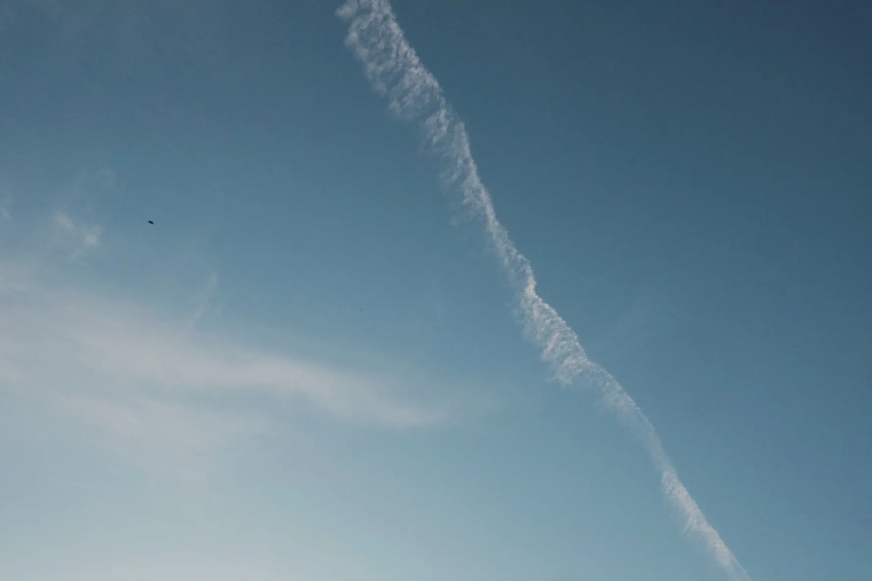 A contrail stretching across the evening sky