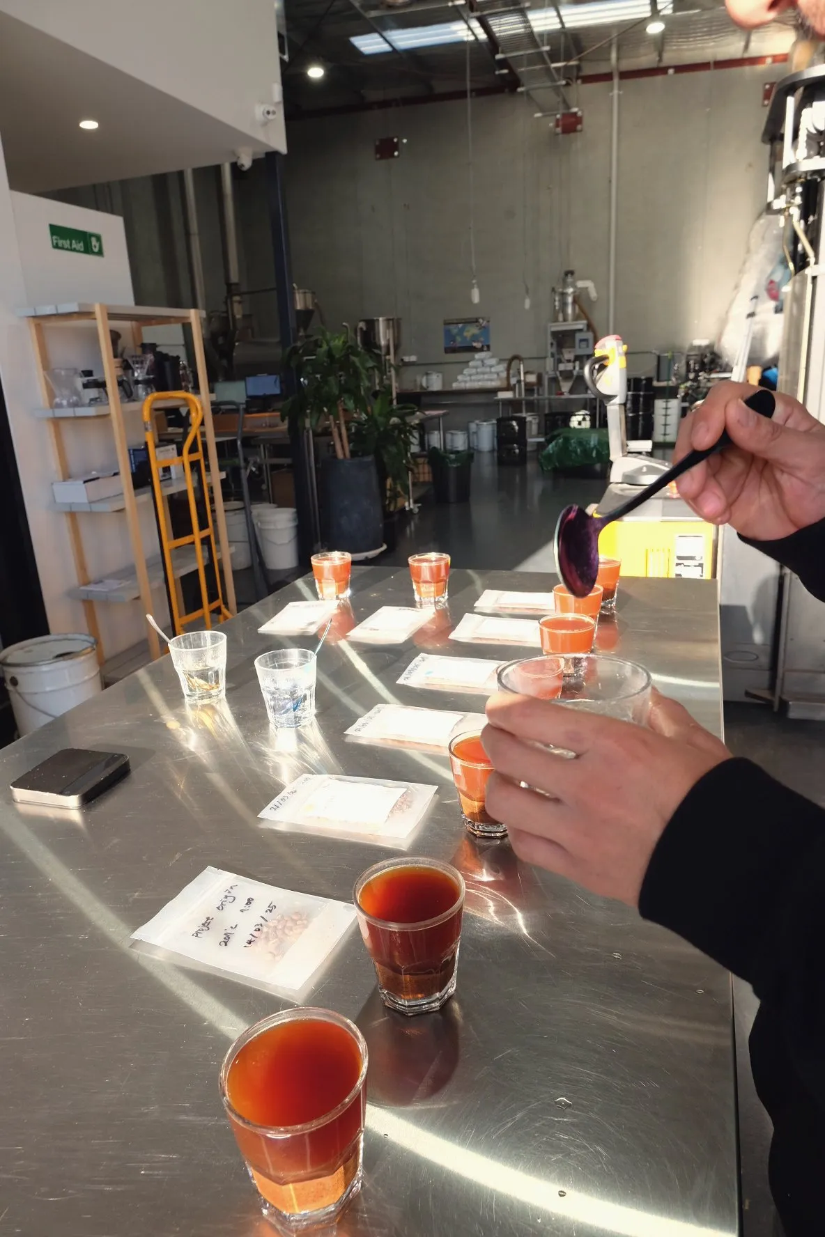 Cupping spoons held in hand during a tasting