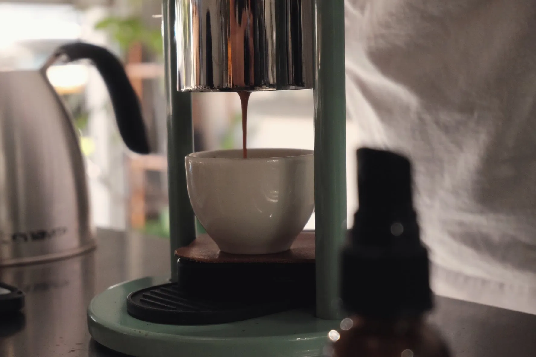 Espresso extracting into a cup, closeup