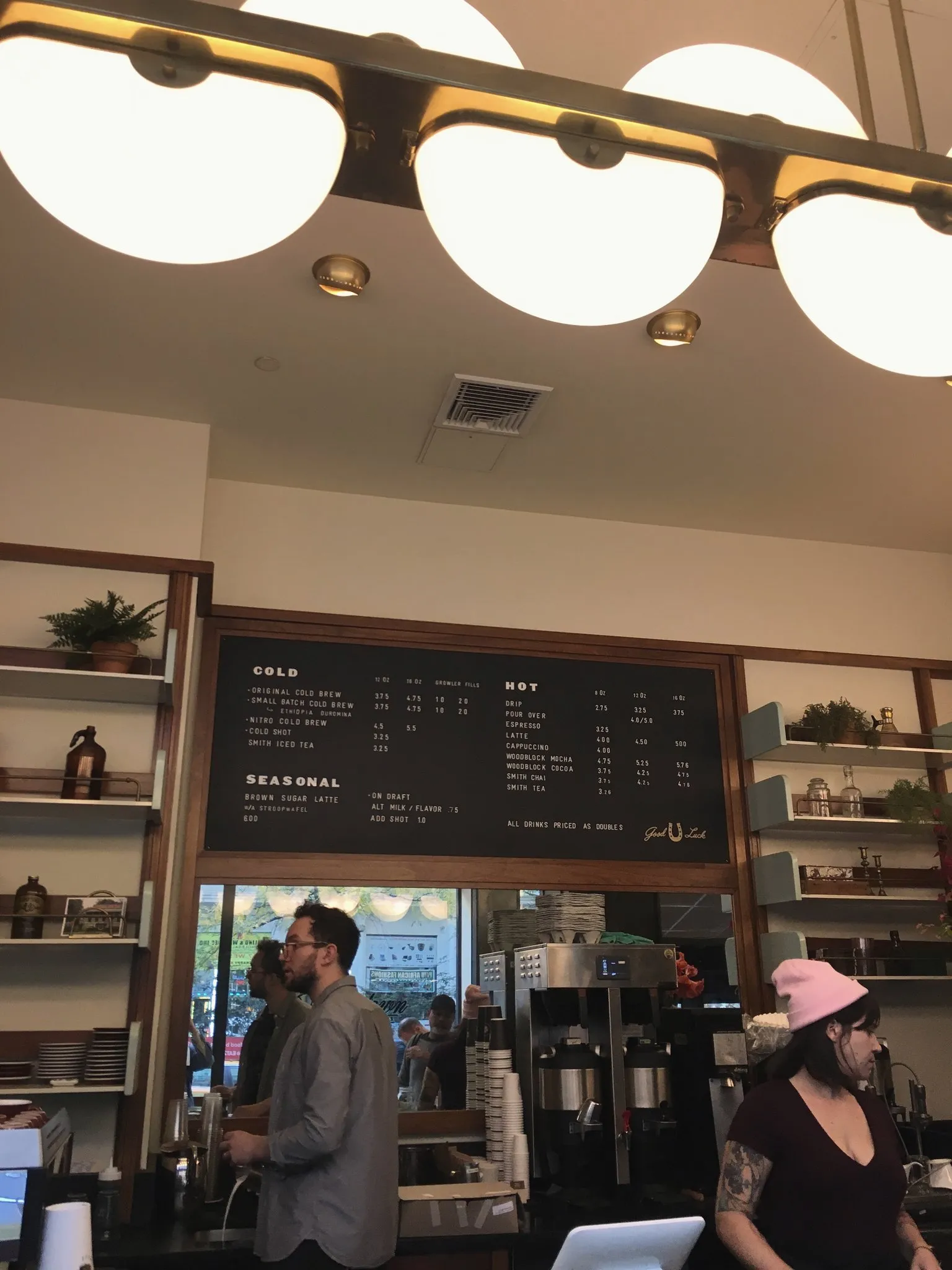 Pendant lights hanging over a café coffee bar